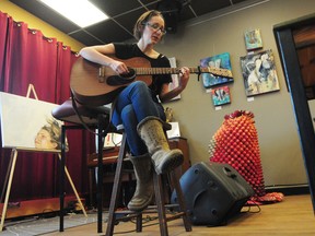 Singer-songwriter Dana Wylie performs a song at the media launch for SkirtsAFire, herArts Festival, at the Carrot Coffehouse, 9351 118 Ave., on Thursday. The inaugural festival showcases the works of female artists across multiple disciplines including music, theatre and poetry. Trevor Robb/Edmonton Examiner