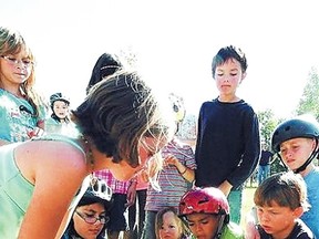 Children pound in the last spike at the unveiling of Hazeldean’s Ghost Rail Sculpture. The six-block greenway project, which includes the sculpture, received a $20,000 grant from the 2011 Living Local Arts and Heritage Program.  FILE PHOTO/TREVOR ROBB