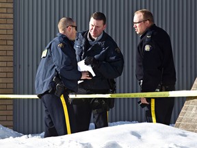 Police are on scene at the court house after two gunmen opened fire on a sheriff in the building before fleeing in Whitecourt, on Tuesday, Feb. 26, 2013. The suspects were apprehended shortly after.