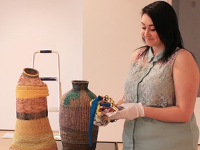 Co-op student Taylor Price from Woodstock Collegiate Institute helped install coil baksets created by artist Nancy Latchford for a new exhibit called Art Beat Junior: The Ripple Effect. The exhibit opens Saturday and includes art created by students from two local schools. SUBMITTED PHOTO