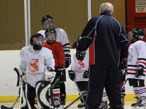 Gilbert Delorme and Richard Sevigny of the Montreal Canadien Alumni team worked with kids from the Cochrane Minor Hockey Association saturday afternoon. Twenty novice and atom players were selected for the clinic.