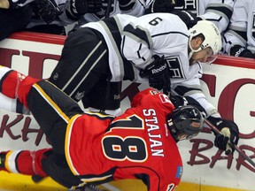 Woodstock's Jake Muzzin, seen here Feb. 20 hitting Calgary Flames Matt Stajan, has seized his opportunity gaining more ice time after injuries depleted the Kings defence early in the season. Muzzin has four goals and three assists in 18 games with a +6 rating, including two goals and assist March 5 against the St. Louis Blues that saw him earn first-star of the game. (QMI Agency file photo)