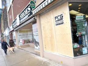 Plywood covers the Sinclair Pharmacy storefront on Thursday where a car drove into a window midday on Wednesday. No one was injured in the incident. (SCOTT, WISHART The Beacon Herald)