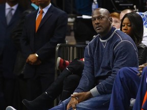 Bobcats owner Michael Jordan watches as his team plays the Bulls during NBA action in Charlotte, N.C. on Feb. 22, 2013. (Chris Keane/Reuters)