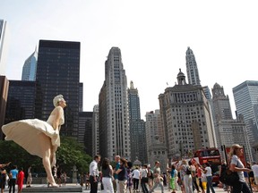 A 26-foot tall statue of Marilyn Monroe is seen against the Chicago skyline, July 15, 2011. The sculpture "Forever Marilyn" by artist Seward Johnson, was based on a scene from the movie "Seven Year Itch."  (Jim Young/Reuters)
