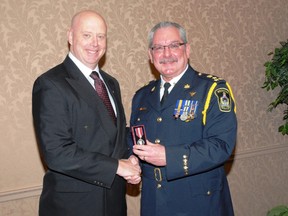Steve Tanner, OCAP president presents Woodstock Police chief Rod Freeman with his Queen's Diamond Jubilee Medal Wednesday, March 6, 2013. 
SUBMITTED PHOTO
