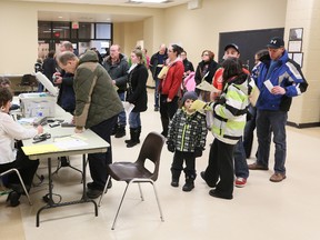 People line up for non-resident cards at a minor sports registration night in Owen Sound.
