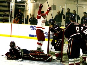 The Edmonton Red Wings were celebrating while the Grove Regals were looking for answers to what went wrong after they were swept from the CJHL playoffs in straight games. Photo by Gord Montgomery/QMI Agency