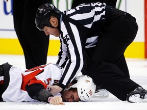 Ottawa Senators forward David Dziurzynski lies on the ice after getting knocked out by the Leafs' Frazer McLaren early in Wednesday's game. (Reuters)