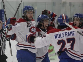 Kingston Voyageurs’ Brett Du Puy, left, celebrates his first-period goal against the Wellington Dukes with teammates during Game 5 of an Ontario Junior Hockey League first-round playoff series at the Invista Centre on Thursday night. The Voyageurs won 3-2 in overtime to eliminate the Dukes. (Ian MacAlpine/The Whig-Standard)
