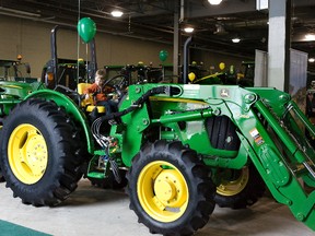 Three year old Ivan Stirling of Iroqoius, Ontario checks out a John Deere tractor at  the London Farm Show on Wednesday, March 6.  (DEREK RUTTAN, The London Free Press)