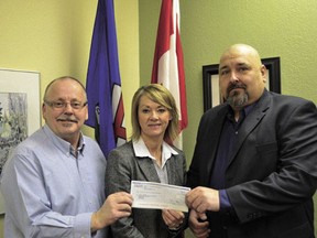 Drayton Valley-Devon MLA Diana McQueen delivers a cheque for $21,500 to Calmar mayor Don Faulkner (left) and Calmar C.A.R.E.S (Cultural, Arts and Recreation Enhancement Society) president Peter Popowich. The money, from the provincial CIP (Community Initiatives program) grant program, will go towards the funding of an electronic community announcement sign to be placed at the east end of Calmar’s town limits on Highway 39.