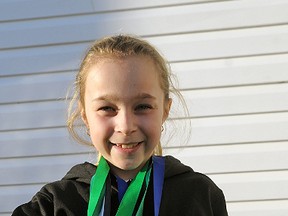 Rachel Thurston, 9, holds the speed skating medals she earned this season skating with the Kitchener-Waterloo Cobras. CHRIS ABBOTT/TILLSONBURG NEWS