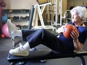 Doris Field, 91, shows off her 'medicine ball twist' skills at Ironworks Fitness during her morning workout. Field, and her friend Ann Maxted, attend the gym three times a week. TARA JEFFREY/THE OBSERVER/QMI AGENCY