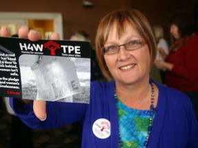 Laurie Intven holds Homes for Women postcard that St. Thomas-Elgin YWCA is urging supporters to send to Prime Minister Stephen Harper to pressure for action on women's homelessness. The YW launched local participation in the national campaign on Friday, March 8, 2013 -- International Women's Day. Eric Bunnell/Times-Journal/QMI Agency