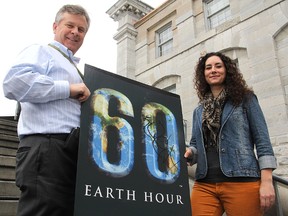 Joe Davis, from Sustainable Kingston, and Tricia Knowles, a co-founder of Unplugged Kingston and the Earth Hour observance, hold a poster promoting this year's Earth Hour, which will be held Sat., March 23 at 8:30 p.m.
Michael Lea The Whig-Standard
