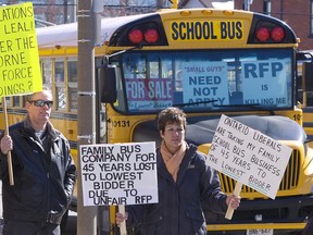 President and manager Rolland Montgomery of Montgomery Transit Ltd., left, and Lisa Howie of Hamilton Bus Lines join school bus operators welcoming MPP Jeff Leal to his new post as rural affairs minister during a rally outside his constituency office on Friday, Mar. 8, 2013 on King St. in Peterborough. The rally attracted over 60 school buses and 30 protestors. Clifford Skarstedt/Peterborough Examiner/QMI AGENCY