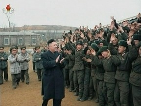 North Korean leader Kim Jong-un applauds as he is welcomed by members of the military at an undisclosed location. (REUTERS)