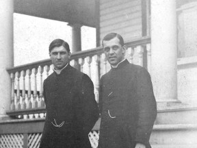 Father Charles-Eugène Thériault and Father Beauregard stand on the steps of the rectory near St. Anthony’s church in 1914.