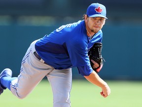 Blue Jays starting pitcher Josh Johnson throws against the Braves in Grapefruit League action in Kissimmee, Fla., on Friday. (Dave Abel/Toronto Sun)