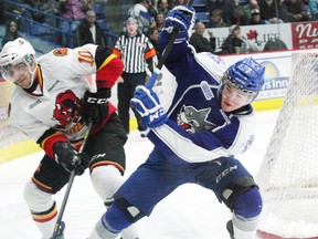 Austen Brassard, left, of the Belleville Bulls, and Ray Huether, of the Sudbury Wolves, battle for possession of the puck during OHL action at the Sudbury Community Arena on Friday, March 8, 2013. JOHN LAPPA/THE SUDBURY STAR/QMI AGENCY