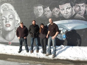 In this file photo, William Andrews, head of operations with Hideaway Pictures, David Anselmo, the company's CEO, Melissa Cormier, an art director on their film The Frozen and Bruno Rocca, the first assistant art director stand next to the studio's movie themed mural.  The Sudbury Star