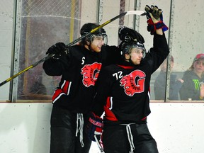 Gananoque Islanders teammates Jon Harris (6) and Chris Smith celebrate Smith's second goal of the game in Friday night's 4-1 win over Athens in game three of the Rideau Division Final at Centre 76. (STEVE PETTIBONE The Recorder and Times)