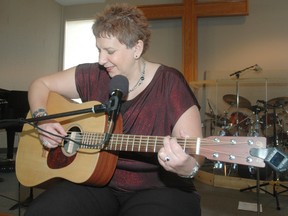 Quebec-based musician and motivational speaker Wendy Farha wams up before a presenation at Fellowship Church Saturday. Farha shares her story during the performances and tries to teach people hwo sadness and despair can be turned into hope and joy. (Nick Lypaczewski, Times-Journal)