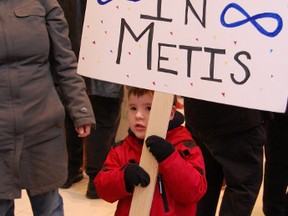 A child holds a sign supporting Metis rights at Winnipeg's James Armstrong Richardson International Airport in Winnipeg on Saturday, March 9, 2013, while awaiting the arrival of Manitoba Metis Federation president David Chartrand. Chartrand was returning from Ottawa after the previous day's ruling from the Supreme Court of Canada on a Metis land dispute with the federal government. (JOHN VANDALE/MMF/HANDOUT)