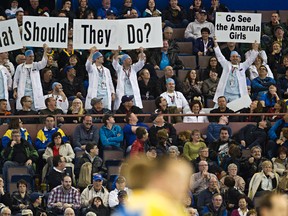 The Sociables hold up signs during the 2013 Tim Hortons Brier at Rexall Place in Edmonton, Alta., on Friday, March 8, 2013. Codie McLachlan/Edmonton Sun/QMI Agency