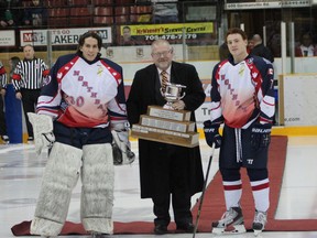 Greg Dodds and Bradley Edwards accept the Copeland Cup from the NOJHL commissioner Robert Mazzuca on Sunday afternoon at the Memorial Gardens prior to the North Bay Trappers last regular season game.