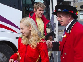 British pairs team Stacey Kemp and David King receive a British-style greeting as they step off the bus Sunday by Tom McGarry, a doorman at the Hilton Hotel, who wearing his traditional Beefeater costume.  (MIKE HENSEN, The London Free Press)