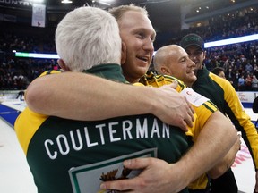 Brad Jacobs gives coach Tom Coulterman a hug.