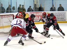 The Carruthers-Nicol Kincardine Bulldogs faced off against the Walkerton Hawks for the Western Jr. C. finals this weekend. Despite a valiant effort, the Hawks would sweep Kincardine in four straight games, including a 6-2 loss on Sunday afternoon. Here, Bulldogs Joel Alton and Jamie Miller look to close in on a loose puck outside the Walkerton crease, but were held off by Hawks defenders.