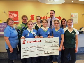 Scotia Bank present a cheque to the Nipawin Pathfinders that will go towards the girls' trip to Churchill.