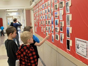 Students at Alder Flats Elementary stop in the hall during lunch break to check out some of the pictures entered for the school’s annual photo contest.
