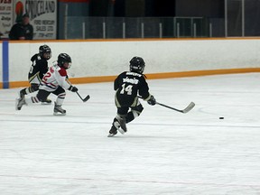 Onoway Vixen players Jack Elliott and Lukas Sawchyn chase the puck with Whitecourt Rampage player Jessie Christie on their tail. The teams were playing on the McLeod Rink at the Scott Safety Centre on March 9 as part of the Initiation Tournament hosted by Whitecourt Minor Hockey.