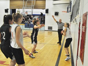 Mayerthorpe Tiger junior girl basketball player, Kalysha Klassen, looks for a teammate to pass to.