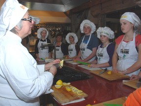 Chef Irene Demas, left, owner of the Wilberforce Cooking Studio in Lucan, instructs students on the basics of cutting a lemon on the first day of the Culinary Boot Camp at the Arts and Cookery Bank in West Lorne. The camp is being held for five days.