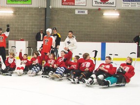Contributed Photo
Members of the Norfolk County OPP Auxiliary Police team and the South Coast Special Needs Kids Sledge Hockey team after participating in the Charity Sledge Hockey Game in 2012. This year's game will take place March 17 at the Waterford Tricenturena.