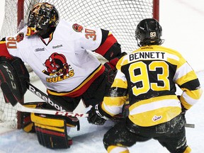 Belleville Bulls goalie Malcolm Subban deflects a shot wide while Kingston Frontenacs forward Sam Bennett waits for a potential rebound during OHL action Monday night in Kingston. (Ian MacAlpine/QMI Whig Standard)