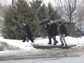 Umbrellas were a necessity in Greater Sudbury on Monday, March 11, 2013. Rain is expected to change to snow today (Tuesday) as colder air moves in. Snowfall amounts are not expected to be significant. JOHN LAPPA/THE SUDBURY STAR/QMI AGENCY