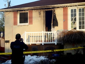 TRENTON, ON (03/12/2013) A member of the Quinte West OPP takes photos at the scene of a deadly house fire in Trenton on the morning of Tuesday, March 12, 2013.  One man died in the fire while six others, including three children, escaped. 
EMILY MOUNTNEY/TRENTONIAN/QMI AGENCY