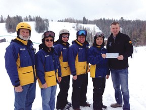 Patrollers Fred Zroback, John Haller, Colleen Cederwall, Shawn Stevenson, Lynn Ronnebeck are handed a cheque by Christian Labour Association of Canada member Colin Bergman.
DAN DYKSTRA PHOTO