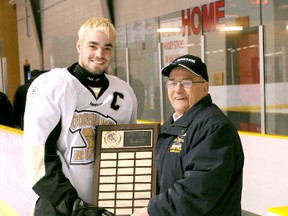 Timmins Midget Hockey Association representative Bill Laffin, right, presents Cochrane Rush captain Alexandre Papineau with the TMHA’s award being the TMHA regular season champions. The award was presented at the Tim Horton Event Centre prior to a playoff game against the Porcupine Gold Kings. The Rush defeated the Gold Kings in first-round playoff action and will now meet the Schumacher Cubs.