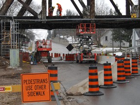 Employees from CN Railway worked on the 110-year-old train overpass Tuesday, March 12, 2013. There are no safety concerns with the bridge, but workers will be on hand doing regular maintenance until the end of June. (TARA BOWIE, Sentinel-Review)