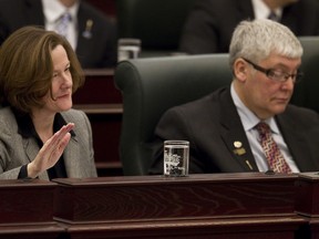 Premier Alison Redford (left) and Minister of Human Resources Dave Hancock listen as Alberta Finance Minister Doug Horner delivers the budget at the Alberta Legislature in Edmonton, Alta., on Thursday, March 7, 2013. Budget 2013 sets out the government's spending and saving proposals for the coming year. Ian Kucerak/Edmonton Sun/QMI Agency