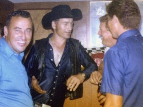 Stompin' Tom Connors, second from left, speaks with Fred Gibson, left, and Walter Pennock, right, at Gibson's house party on Wiley Street in 1971, following his concert at the Kingston Speedway.