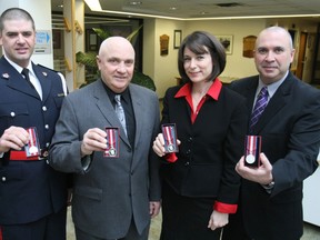 Four members of the North Bay Police Association were awarded the Queen's Diamond Jubilee Medal during the Police Services Board Meeting Tuesday. From left, Const. Merv Shantz, Ivan Ryman, forensic identification officer, Aline Major, administrative assistant and Sgt. Noel Coulas display their medals. The association nominated a number of its members. Tuesday's recipients join almost a dozen others who have also received the medal including Police Chief Paul Cook, Retired Deputy Chief Al Williams, Deputy Chief Shawn Devine, Staff Sgt. Mike Tarini, Const. Jody DeHaas and Const. Aaron Northrup.