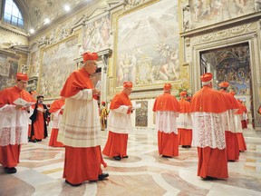 Cardinals enter the Sistine Chapel to begin the conclave in order to elect a successor to Pope Benedict on Tuesday. Shut off from the outside world, the 115 cardinals will cast their ballots in a chapel which has Michelangelo’s soaring Last Judgment on one wall, and his depiction of the hand of God giving life to Adam above them.  
REUTERS/Osservatore Romano